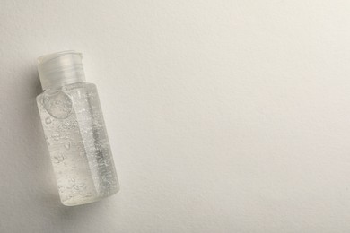 Photo of Bottle of cosmetic gel on white background, top view. Space for text