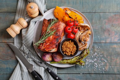 Photo of Delicious grilled meat and vegetables served on wooden table, flat lay