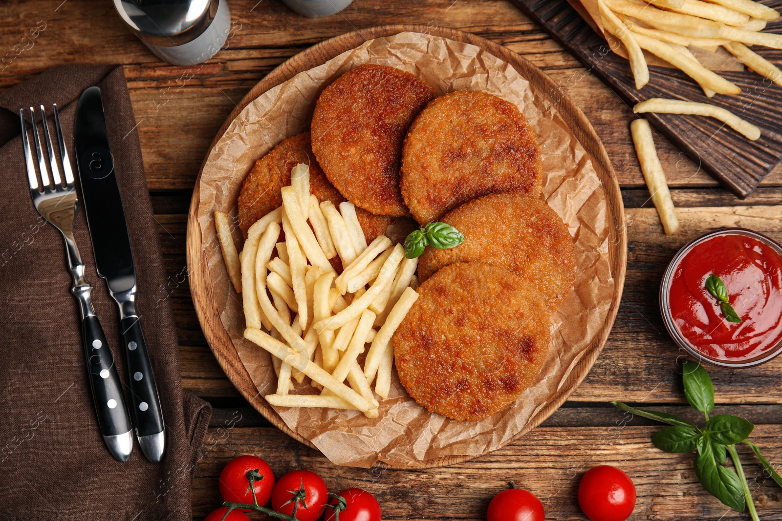 Photo of Delicious fried breaded cutlets served on wooden table, flat lay