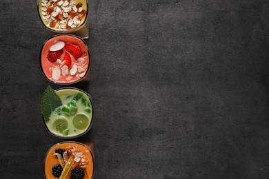 Photo of Many different delicious smoothies on grey table, flat lay. Space for text