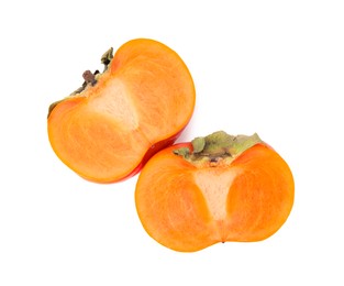 Photo of Halves of delicious ripe juicy persimmons on white background, top view