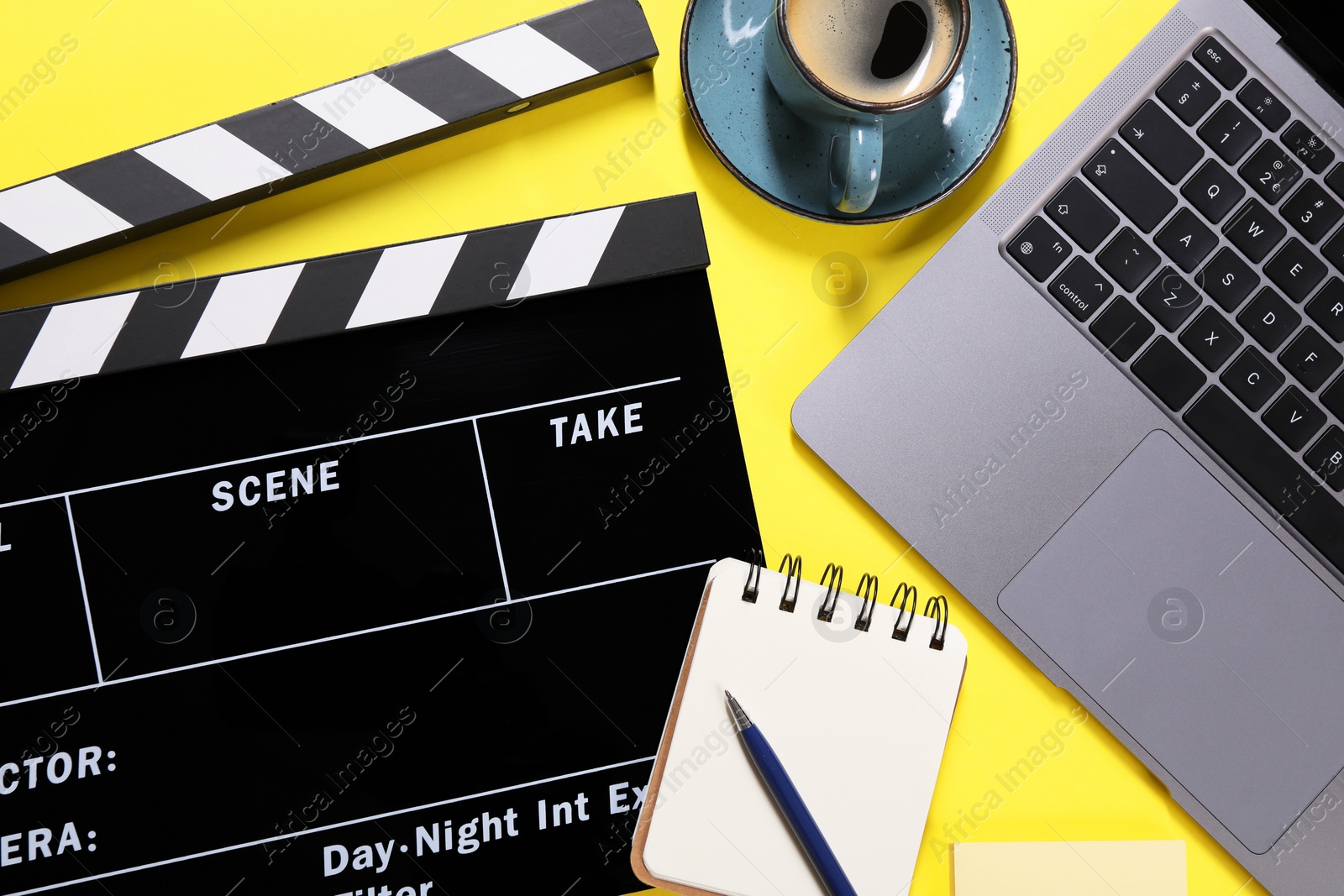 Photo of Flat lay composition with movie clapper on yellow background