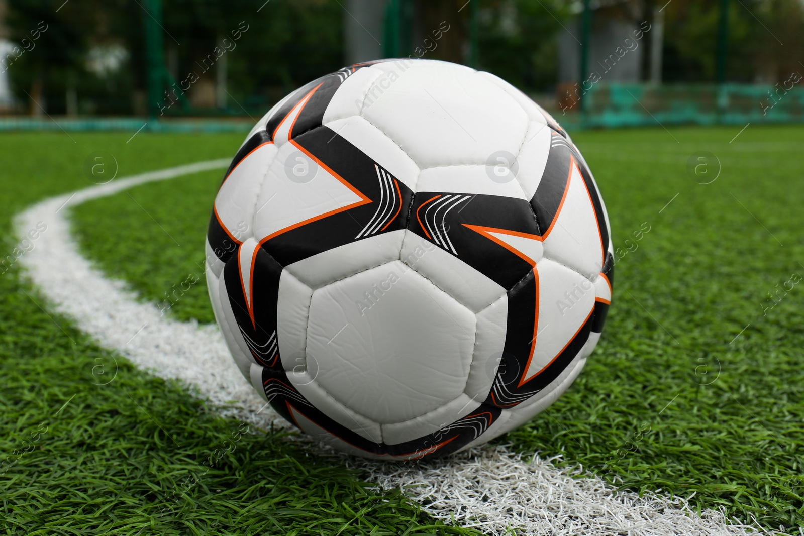 Photo of New soccer ball on green football field