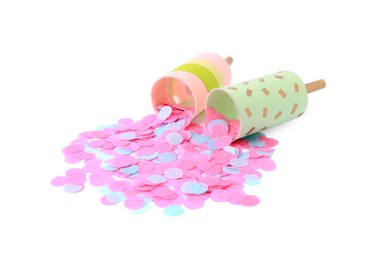 Photo of Colorful confetti with pink party crackers isolated on white
