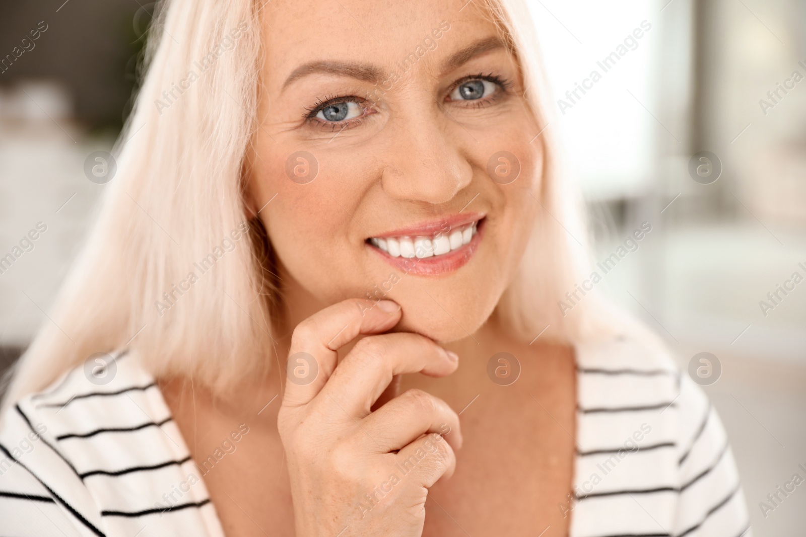 Photo of Portrait of mature woman with beautiful face on blurred background, closeup view
