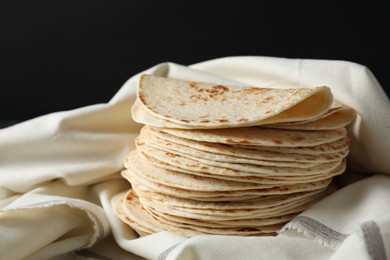 Photo of Stack of tasty homemade tortillas on table