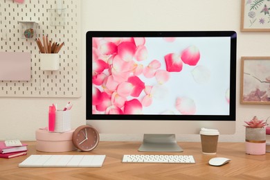 Photo of Stylish workplace with computer on wooden desk near white wall. Interior design