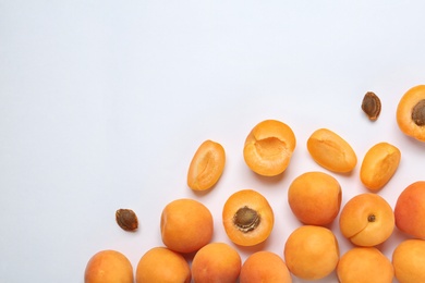 Delicious ripe sweet apricots on white background, top view. Space for text