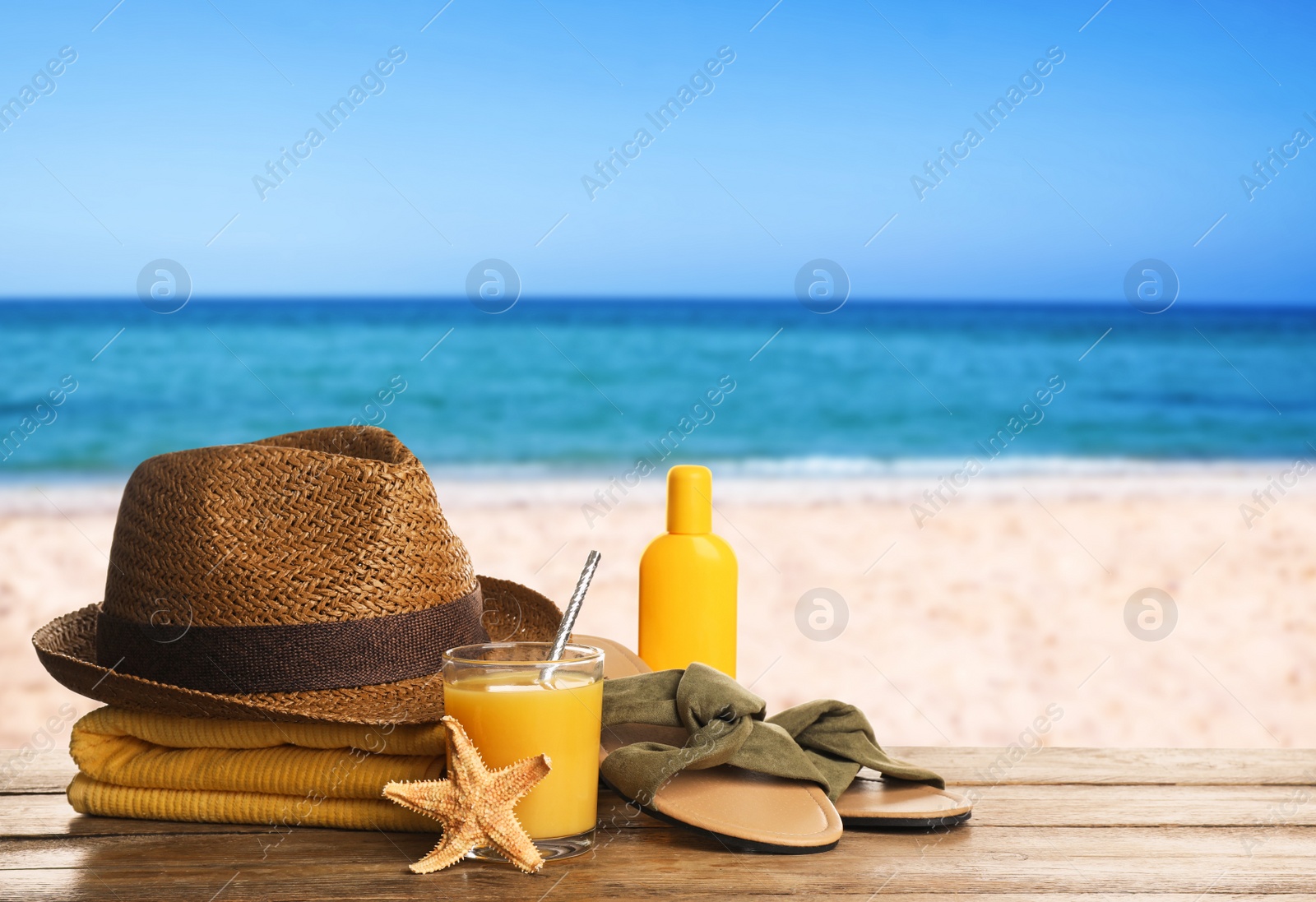 Image of Different beach objects on wooden surface near sea