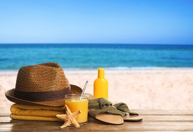 Image of Different beach objects on wooden surface near sea