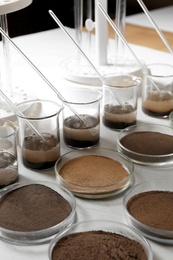 Glassware with soil samples and extracts on light table. Laboratory research