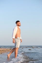 Young man enjoying sunny day on beach