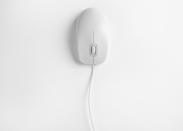 Modern wired optical mouse on white background, top view