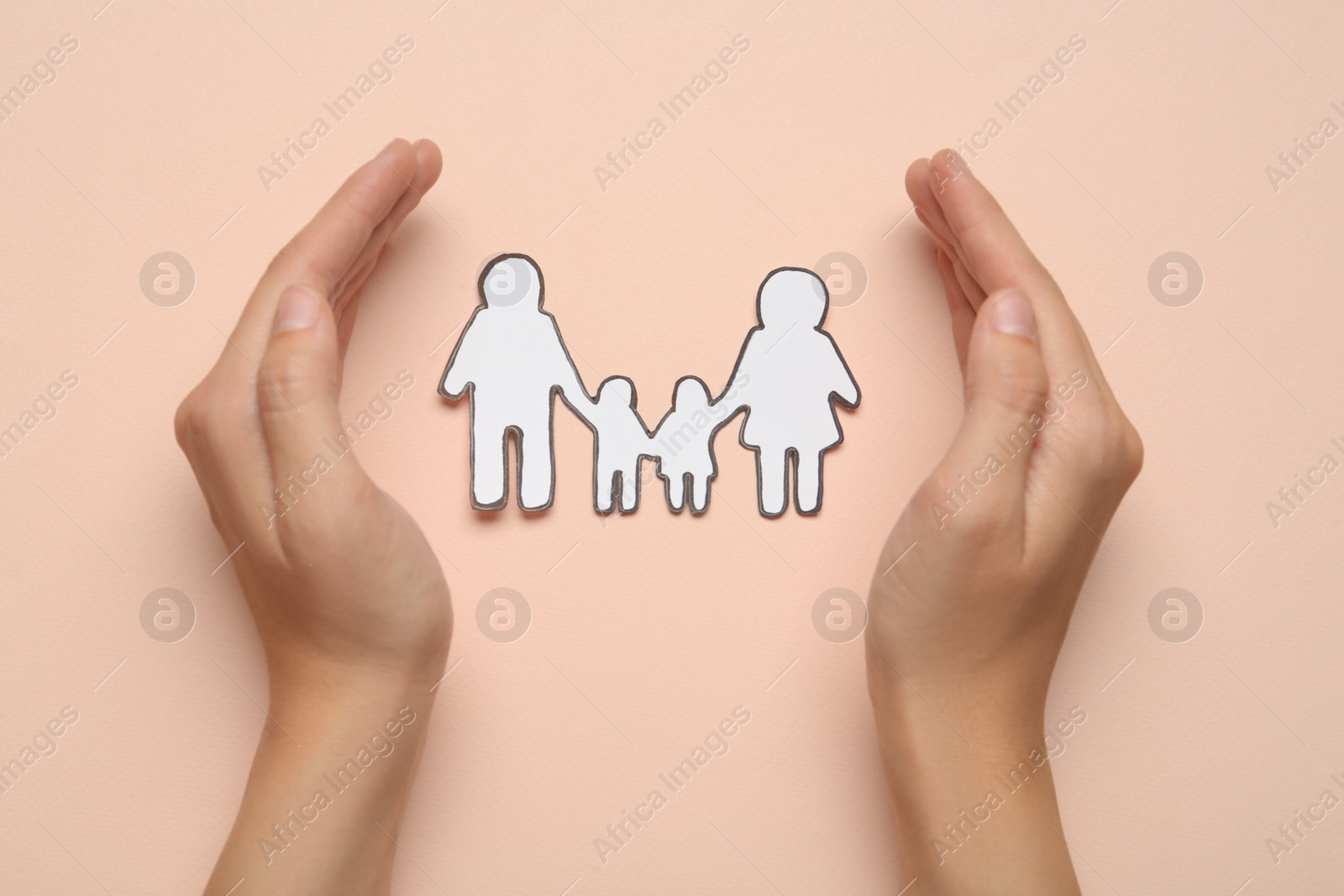 Photo of Woman with paper family cutout on beige background, top view