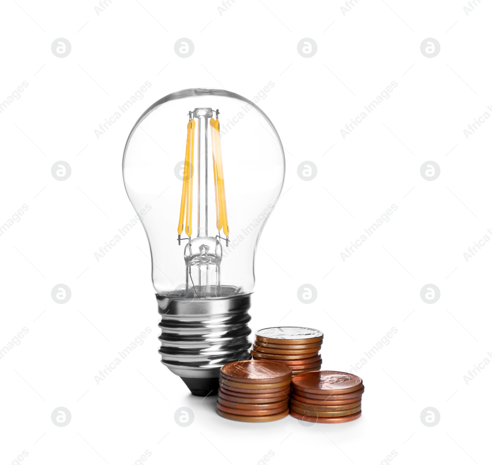 Photo of Lamp bulb and coins on white background. Money saving concept