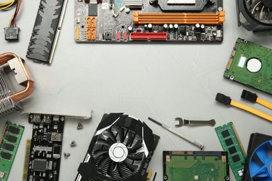 Photo of Frame of graphics card and other computer hardware on gray background, flat lay. Space for text