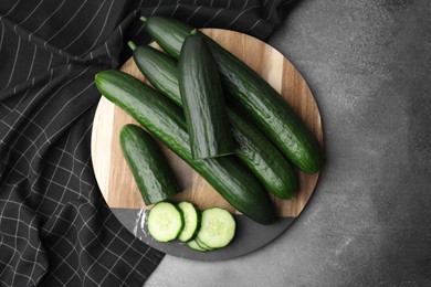 Fresh cucumbers on grey textured table, top view