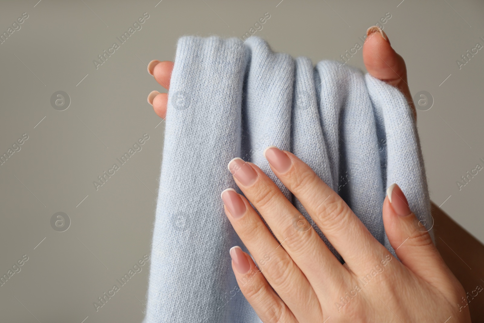 Photo of Woman with cashmere sweater on beige background, closeup