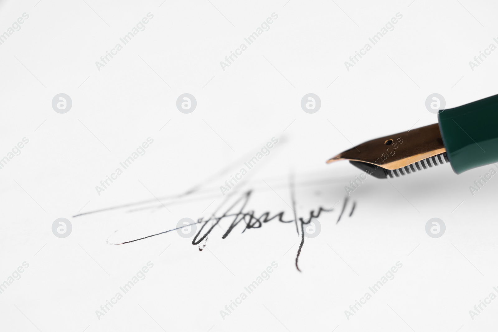 Photo of Fountain pen and signature on sheet of paper, closeup. Space for text