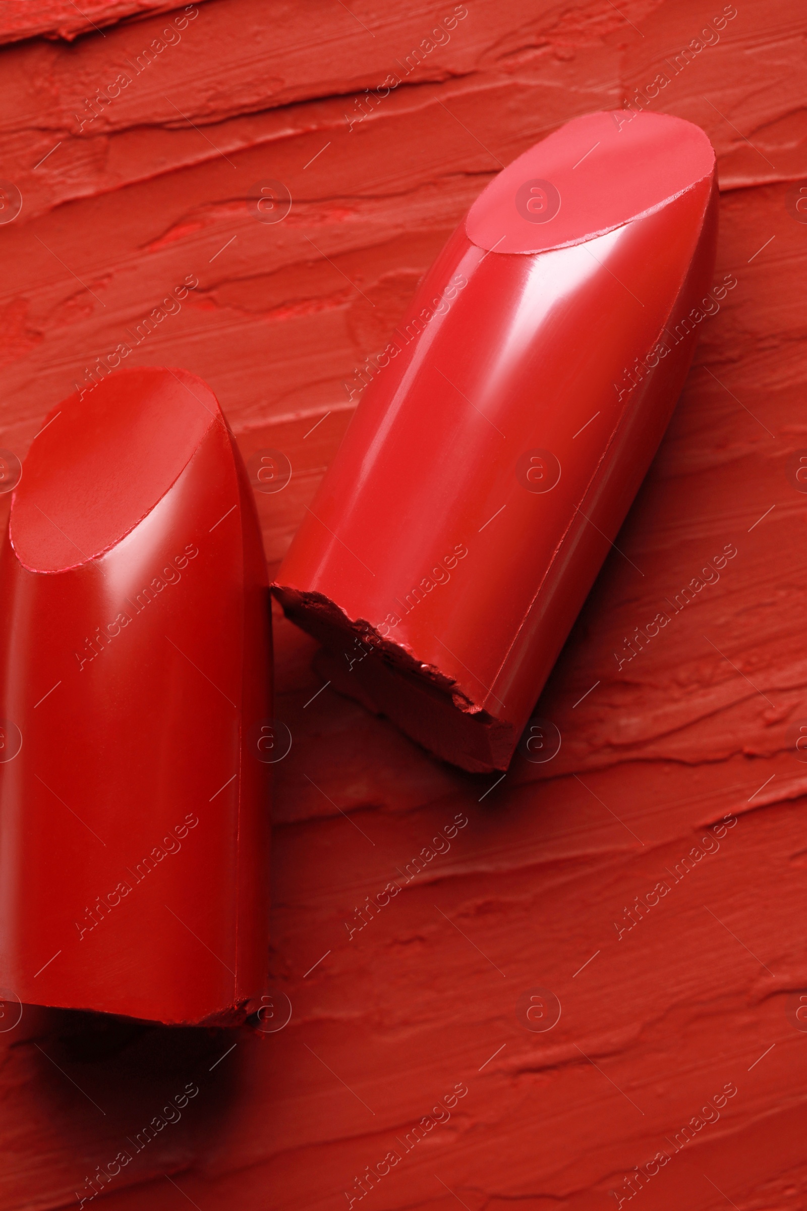 Photo of Many bright lipsticks and smears, top view