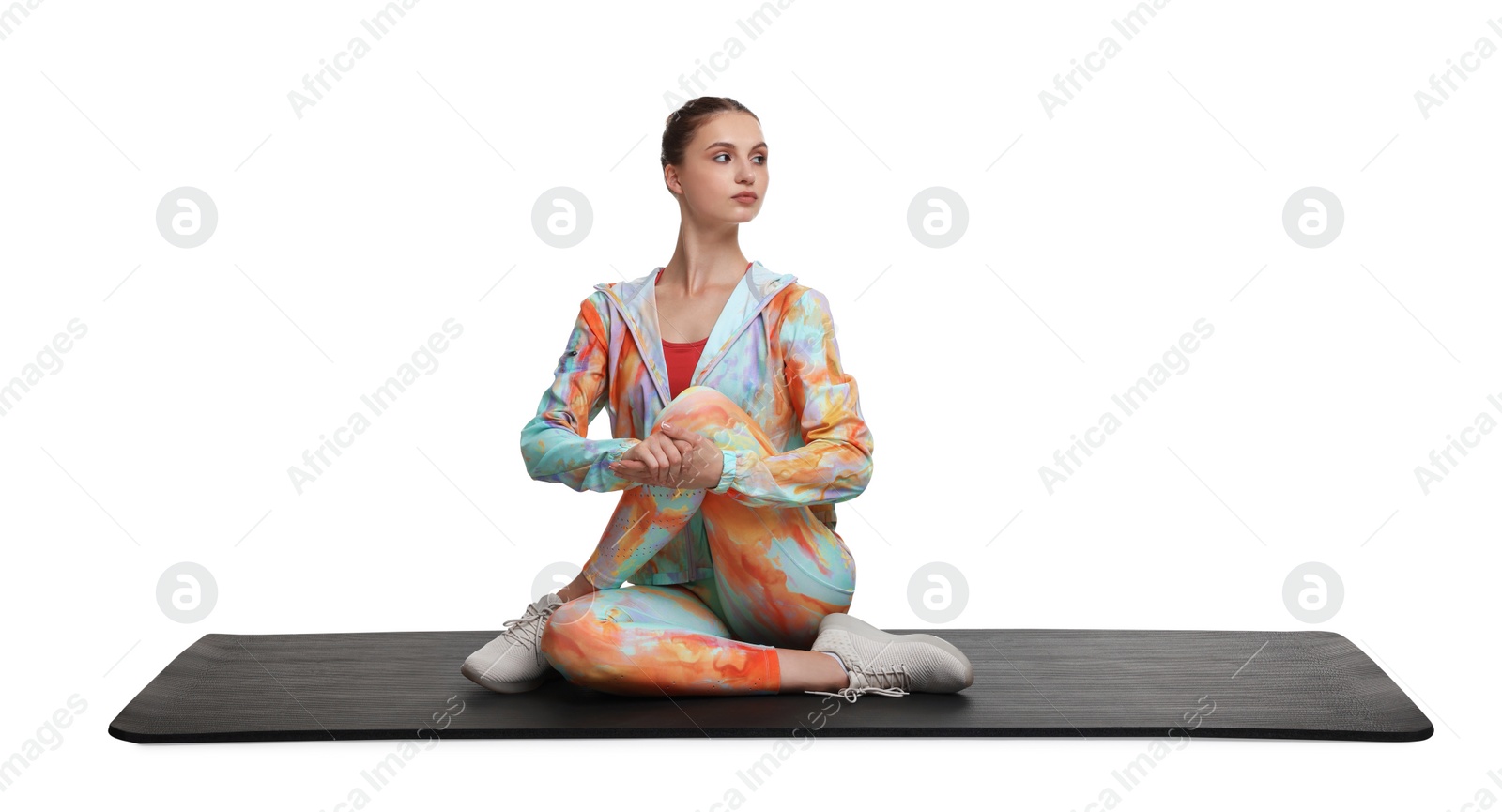 Photo of Yoga workout. Young woman stretching on white background