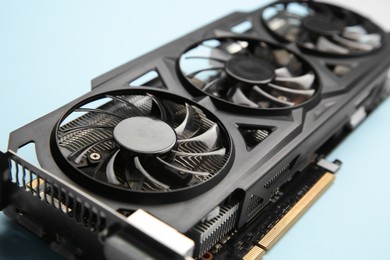Photo of One graphics card on light blue background, closeup