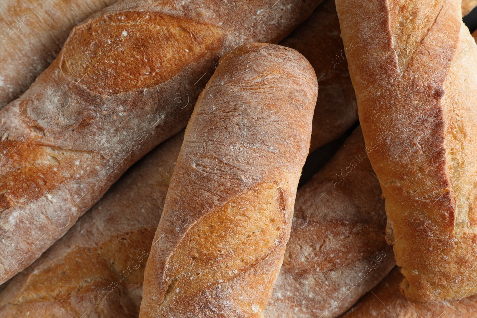 Photo of Crispy French baguettes as background, top view. Fresh bread