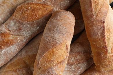 Photo of Crispy French baguettes as background, top view. Fresh bread