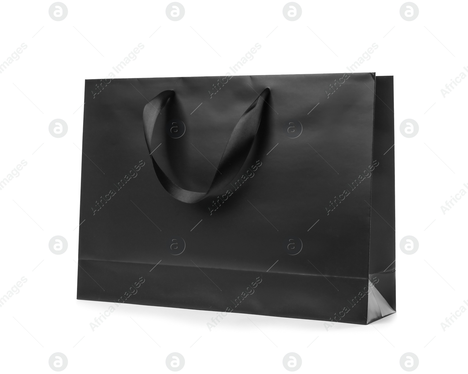 Photo of Paper shopping bag with ribbon handles on white background. Mockup for design