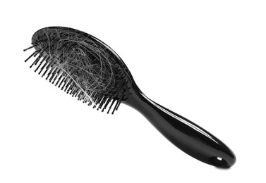 Photo of Brush with lost hair in air on white background