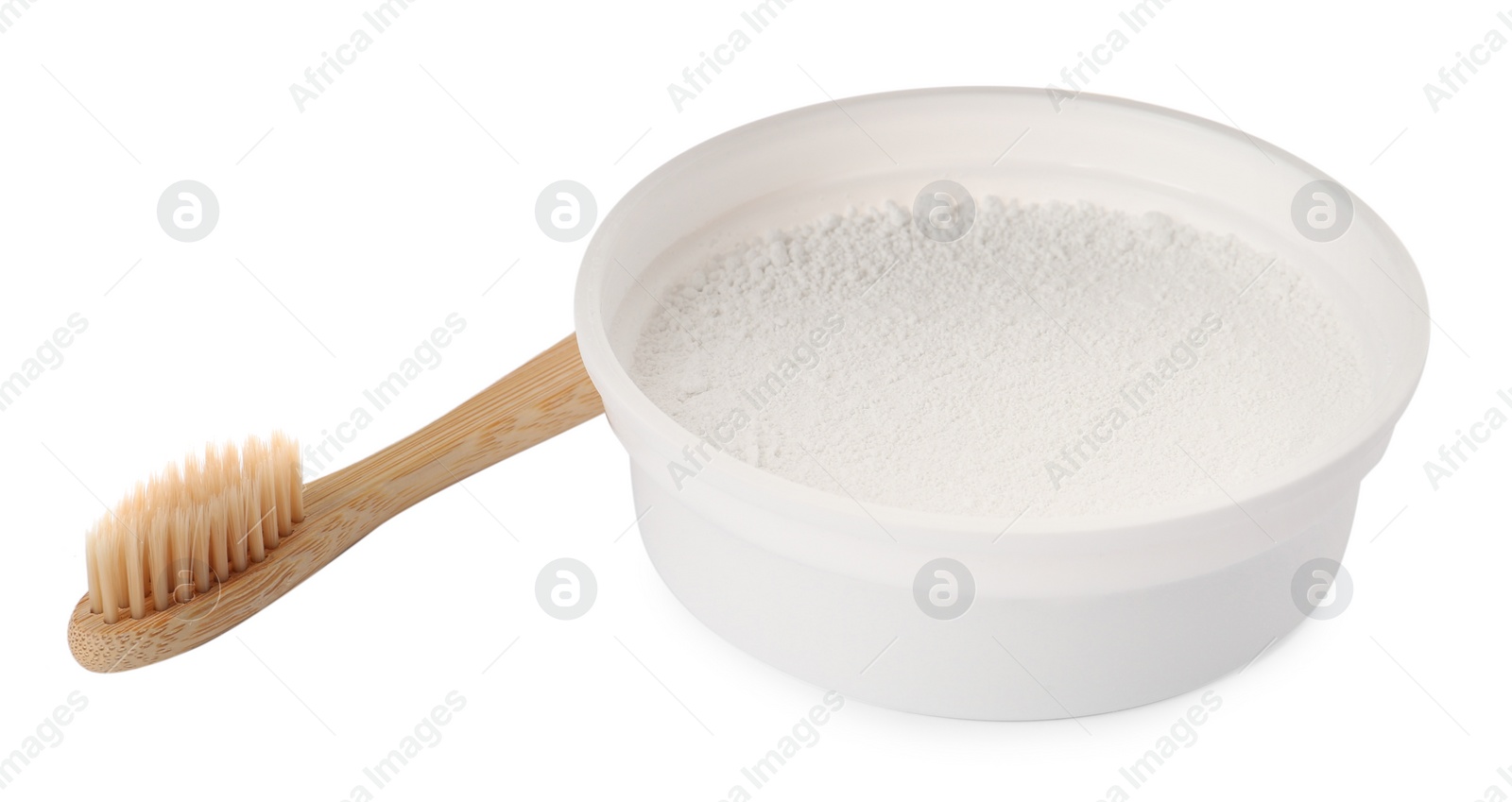 Photo of Bowl of tooth powder and brush on white background