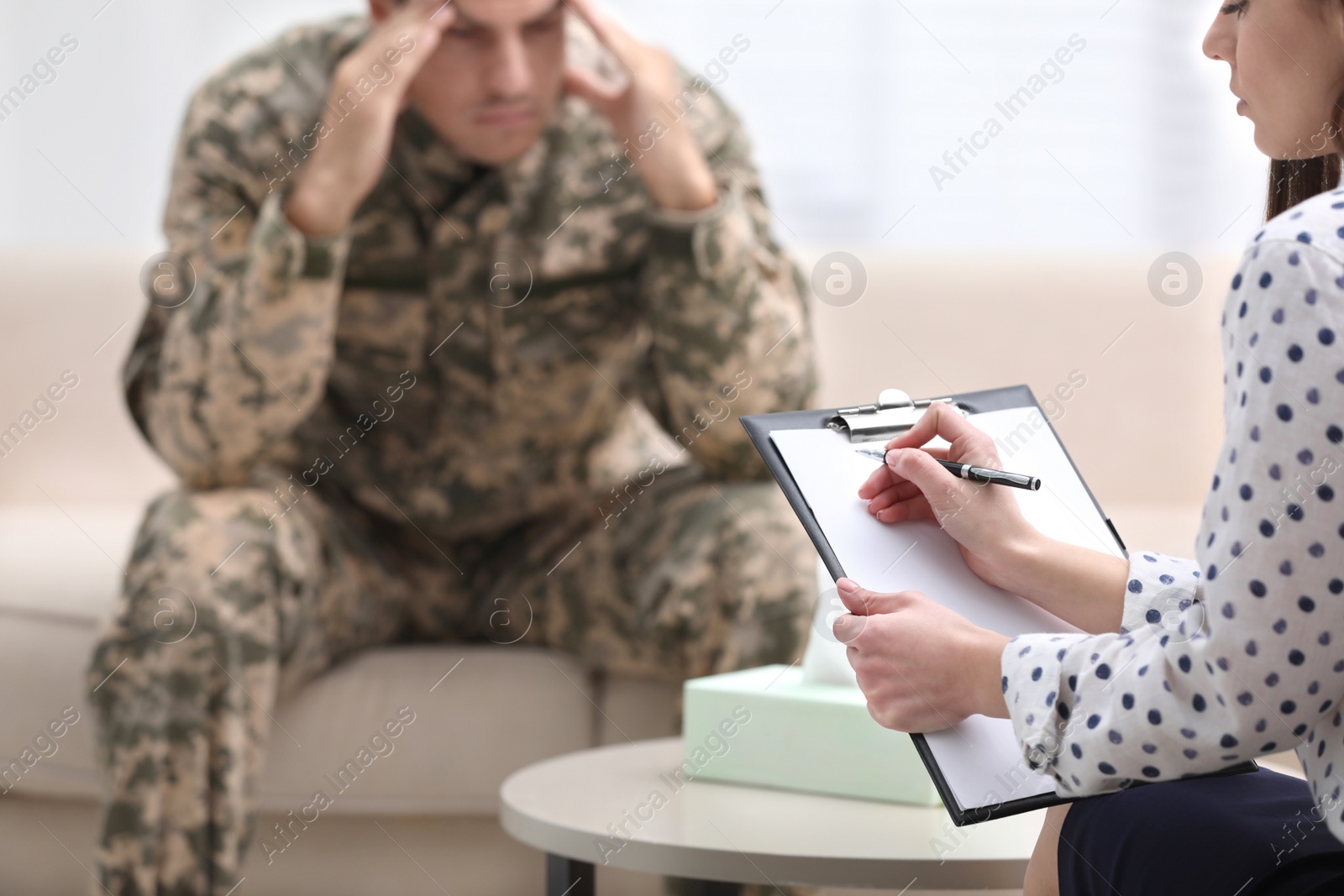 Photo of Psychotherapist working with male military officer in office, closeup