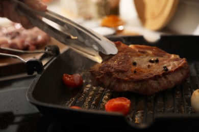 Man cooking meat with vegetables in frying pan, closeup