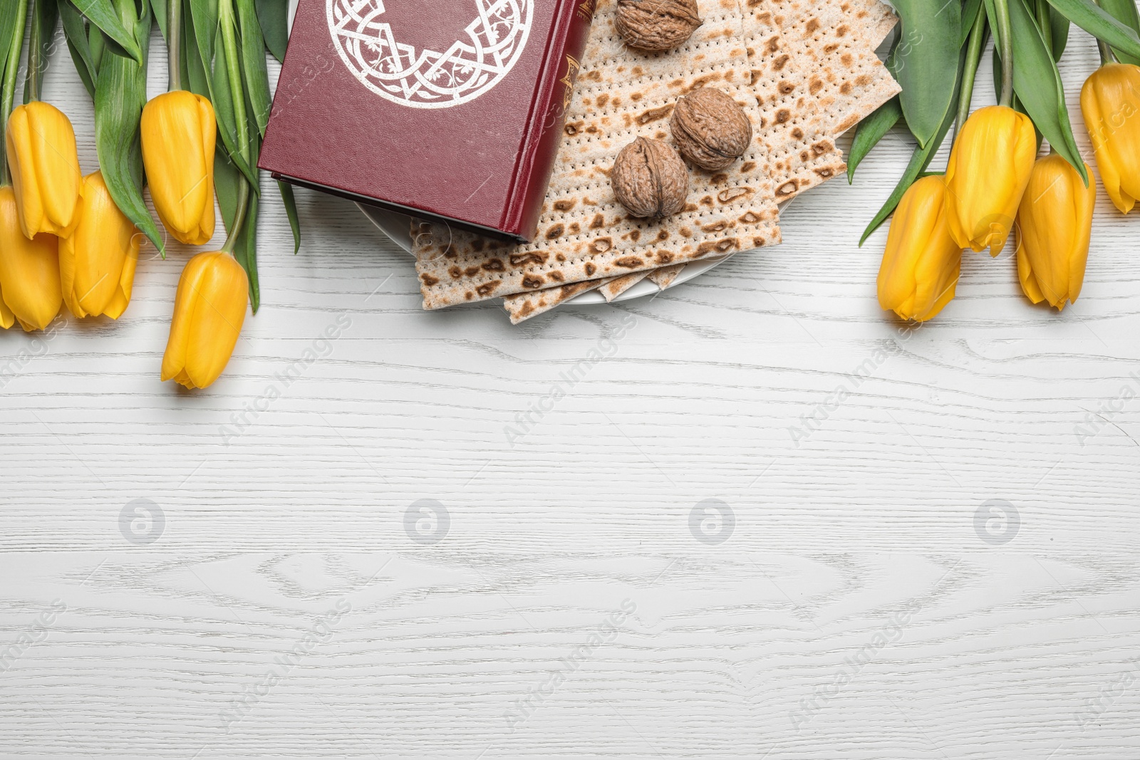 Photo of Flat lay composition with matzo and Torah on wooden background, space for text. Passover (Pesach) Seder