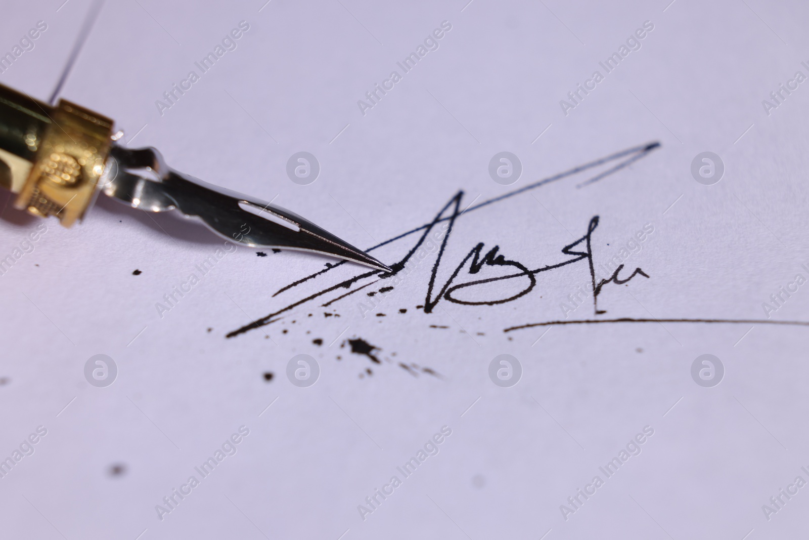 Photo of Signing on sheet of paper with fountain pen, closeup