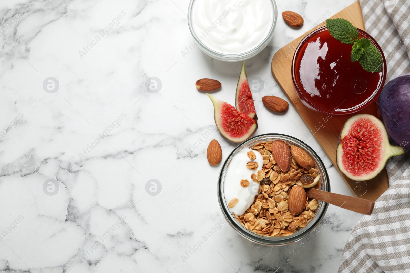 Photo of Healthy homemade granola with yogurt on white marble table, flat lay. Space for text