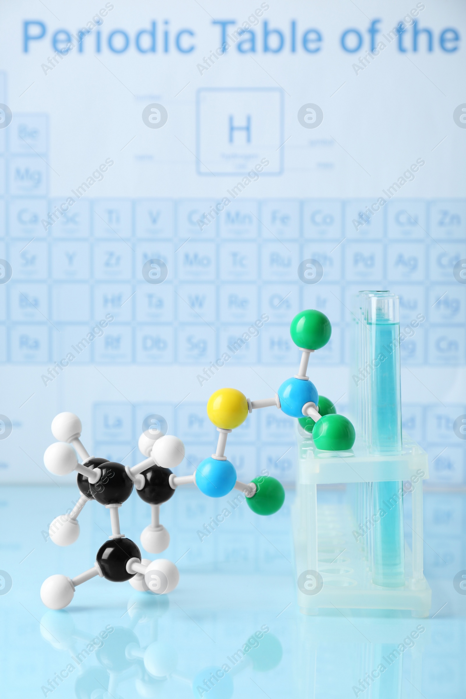 Photo of Molecular model and test tubes on light surface