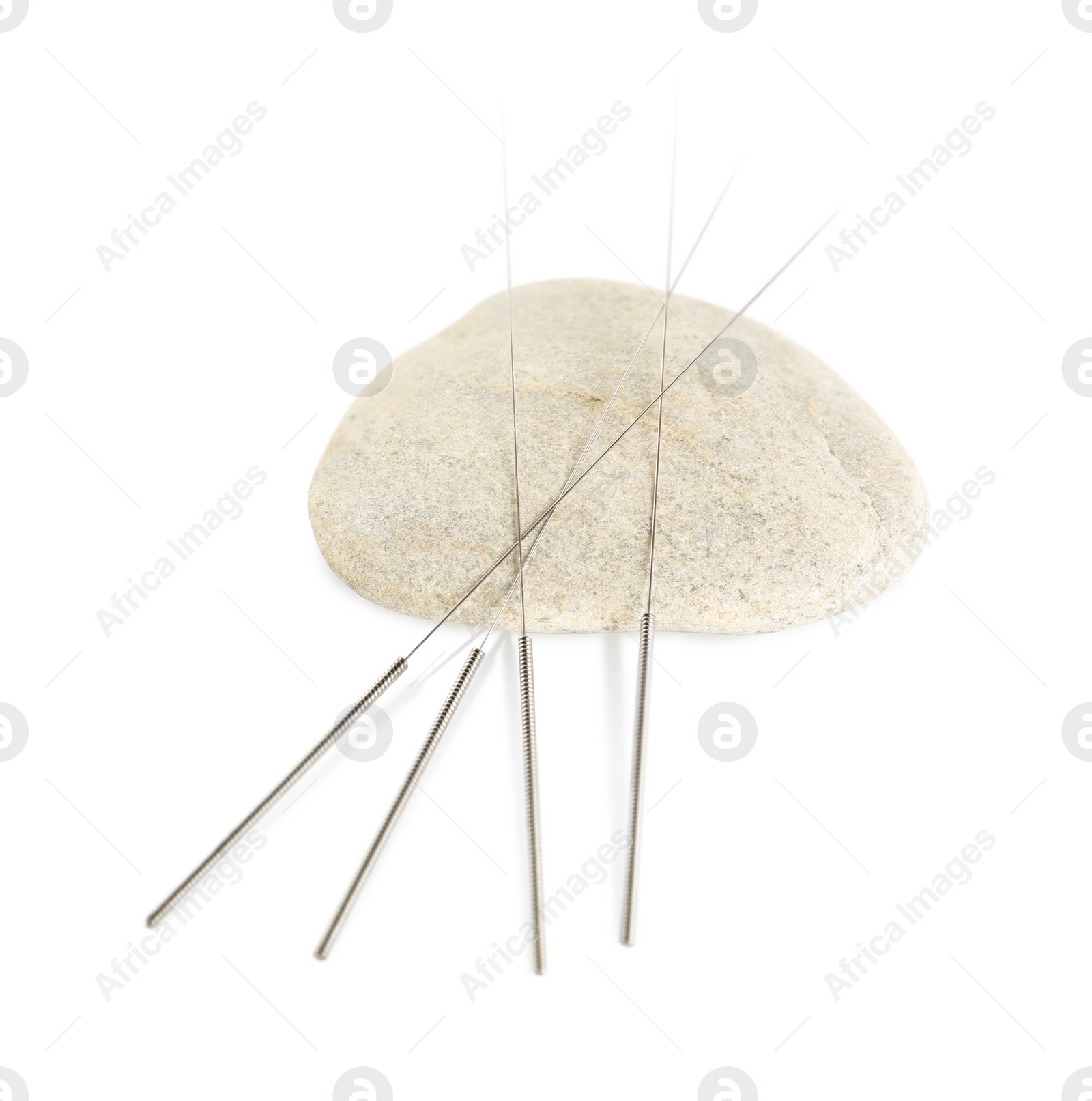 Photo of Many needles for acupuncture and stone on white background, top view