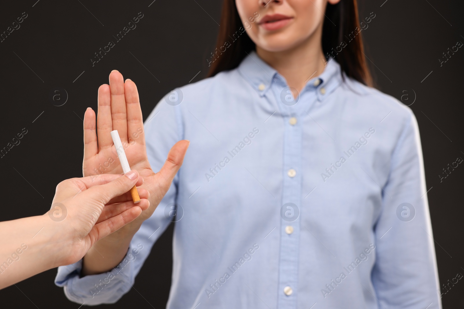 Photo of Stop smoking concept. Woman refusing cigarette on black background, closeup