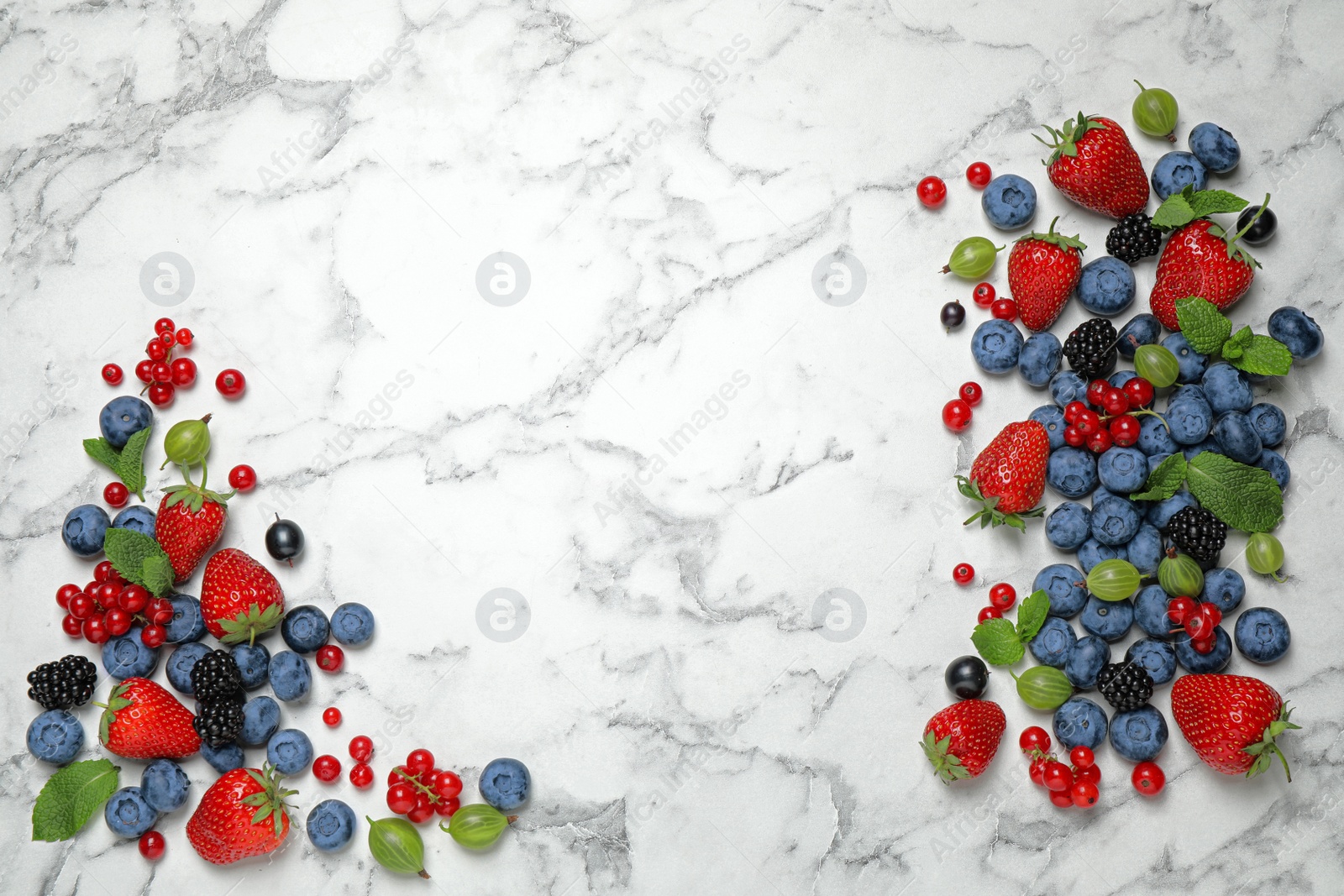 Photo of Mix of fresh berries on white marble table, flat lay. Space for text