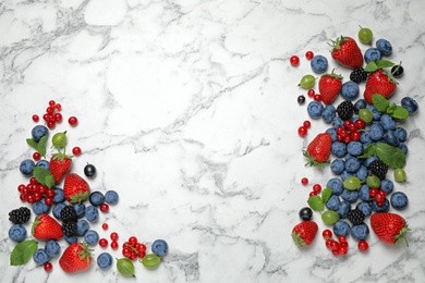 Photo of Mix of fresh berries on white marble table, flat lay. Space for text