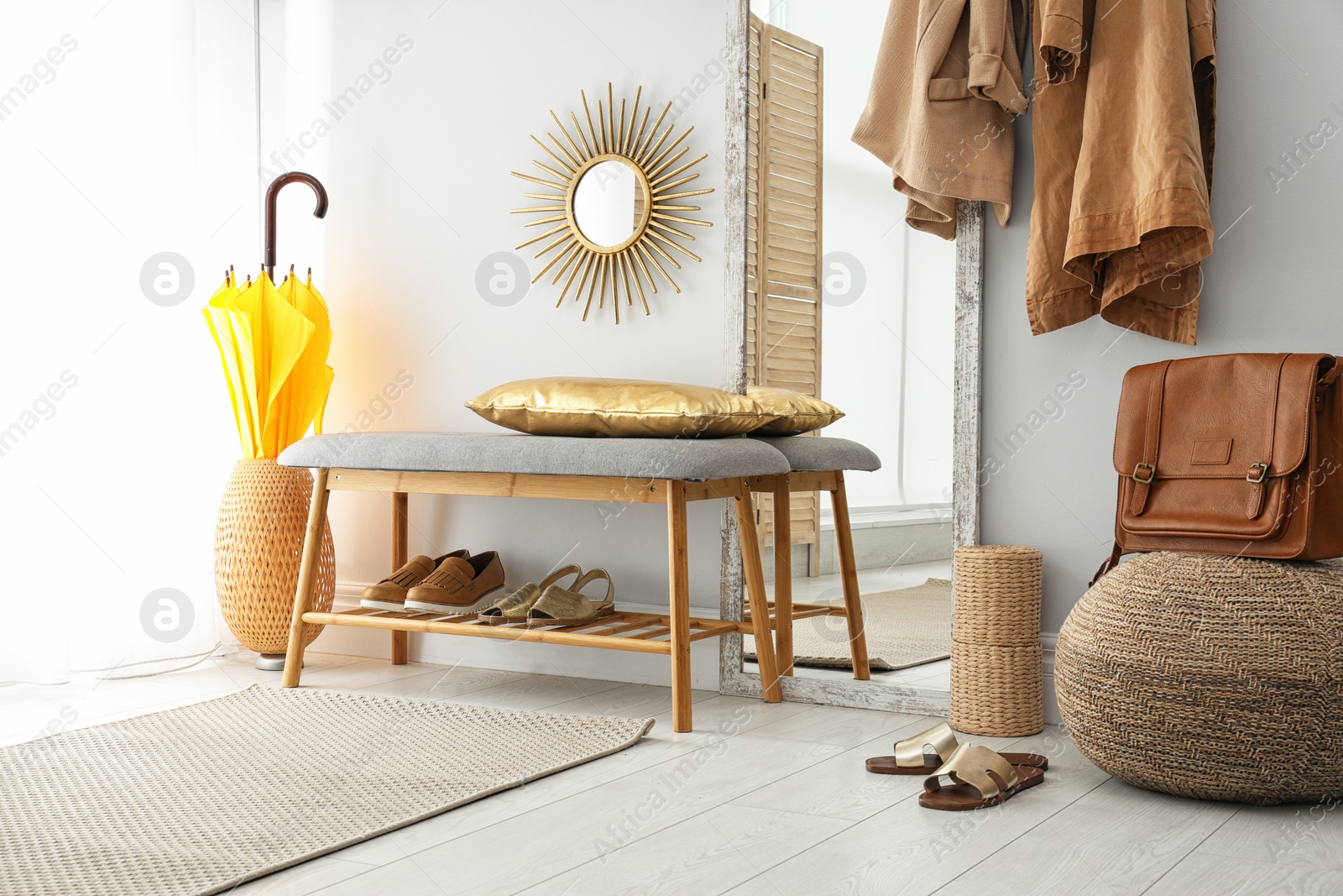 Photo of Stylish hallway interior with large mirror and storage bench near light wall