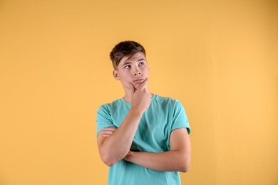 Photo of Teenage boy in casual clothes on color background