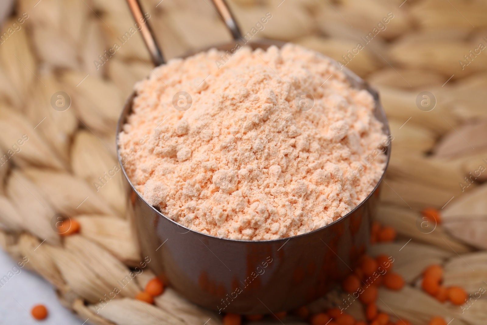 Photo of Organic lentil flour on wicker mat, closeup