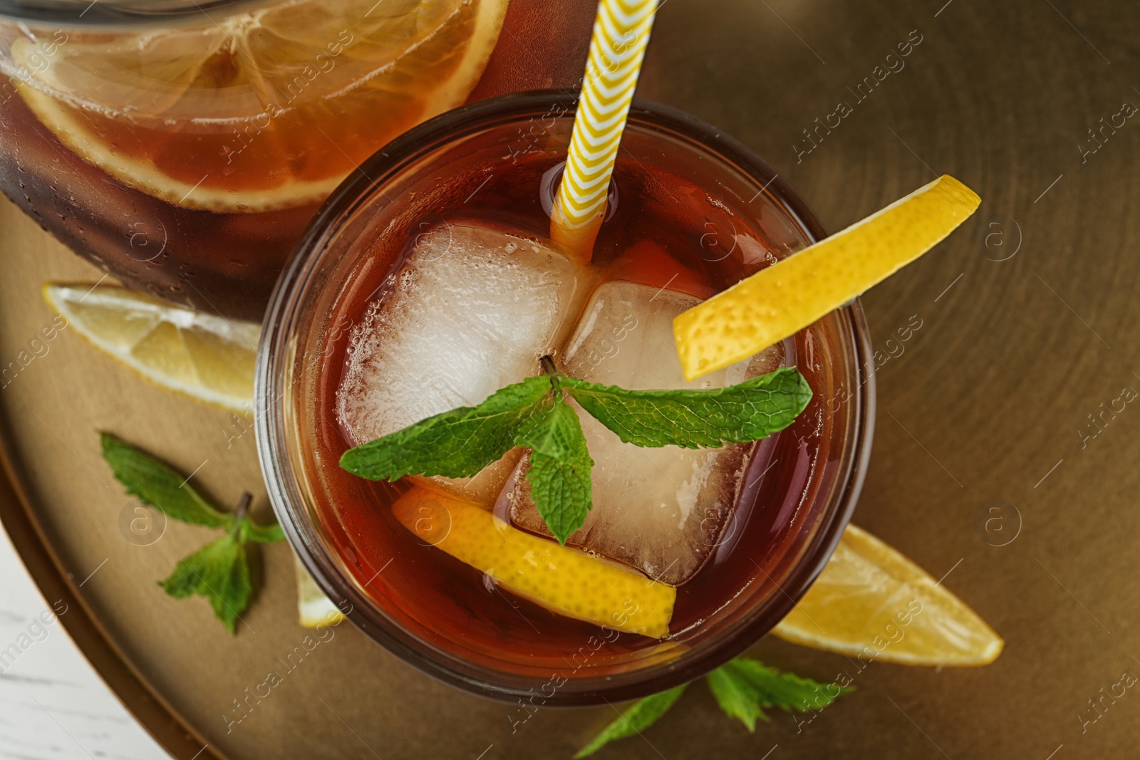 Photo of Jug and glass of delicious iced tea, top view