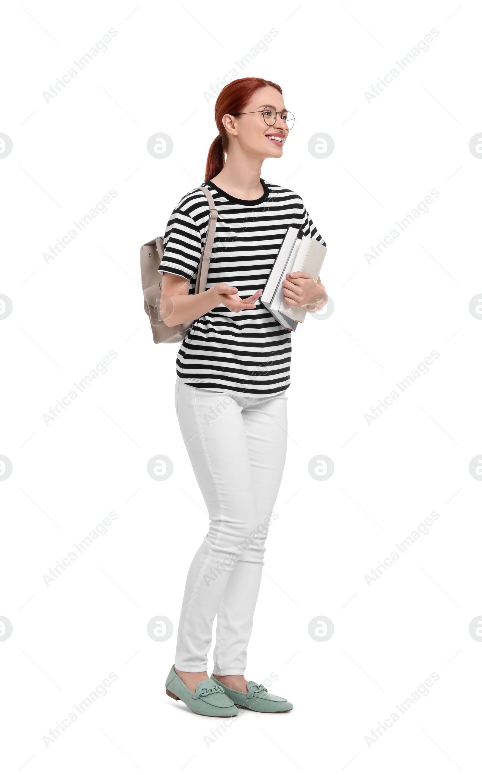 Photo of Happy woman with backpack and books on white background