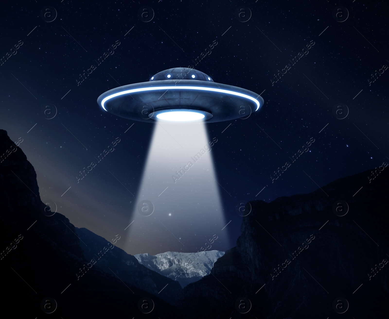 Image of UFO. Alien spaceship emitting light beam over mountains at night, illustration