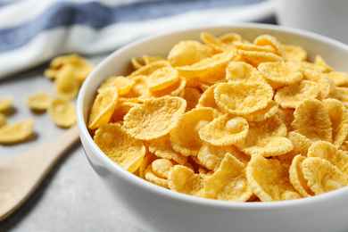 Tasty corn flakes on light grey table, closeup