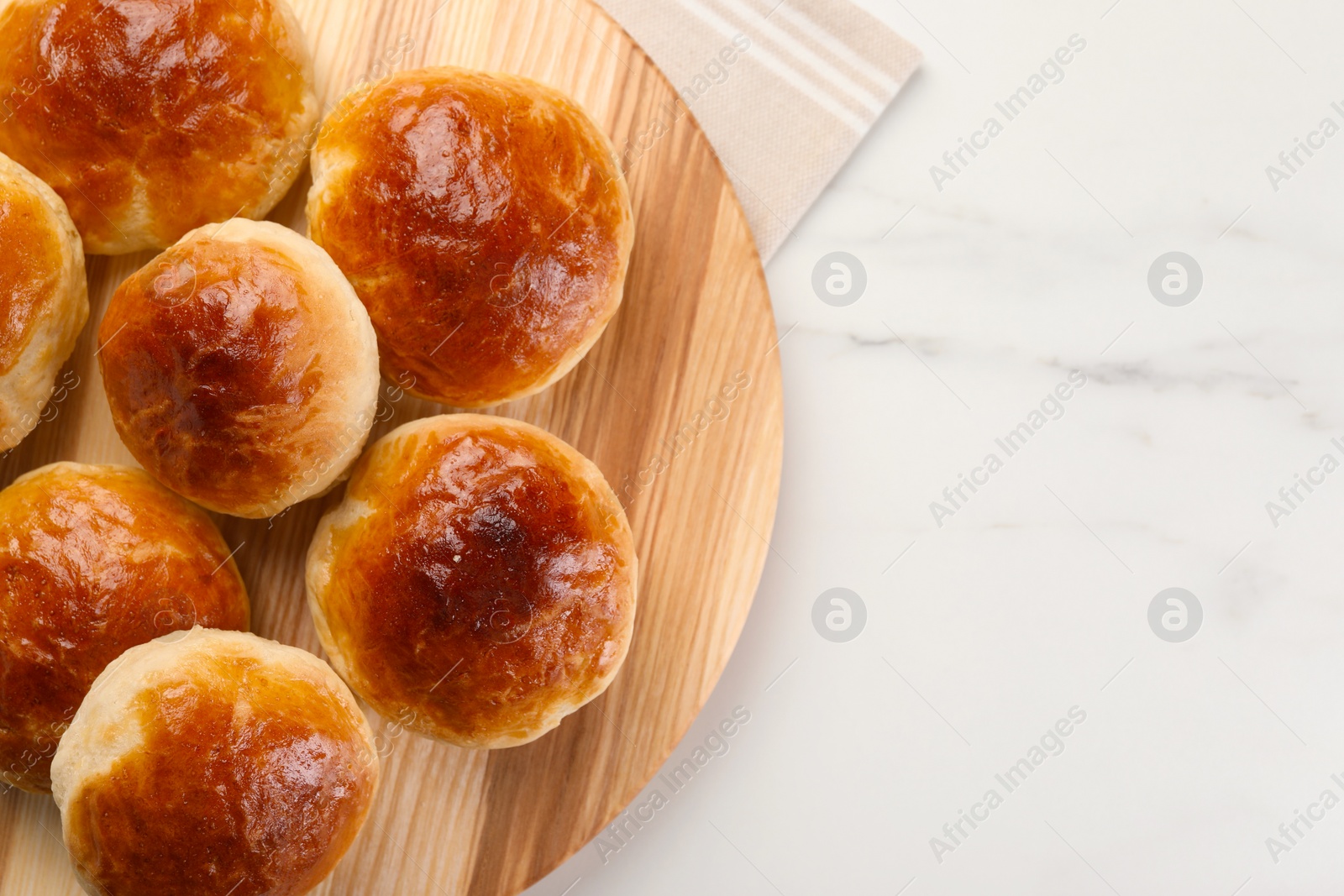 Photo of Tasty scones prepared on soda water on white marble table, top view. Space for text