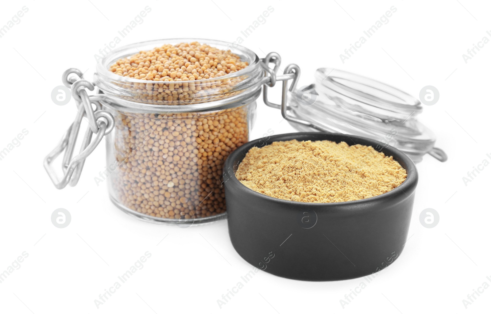 Photo of Aromatic mustard powder in bowl and glass jar with seeds on white background